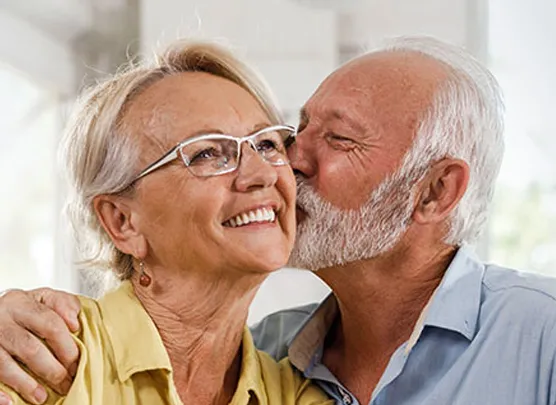 Man kissing his wife on the cheek