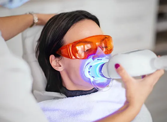 Woman undergoing teeth whitening procedure